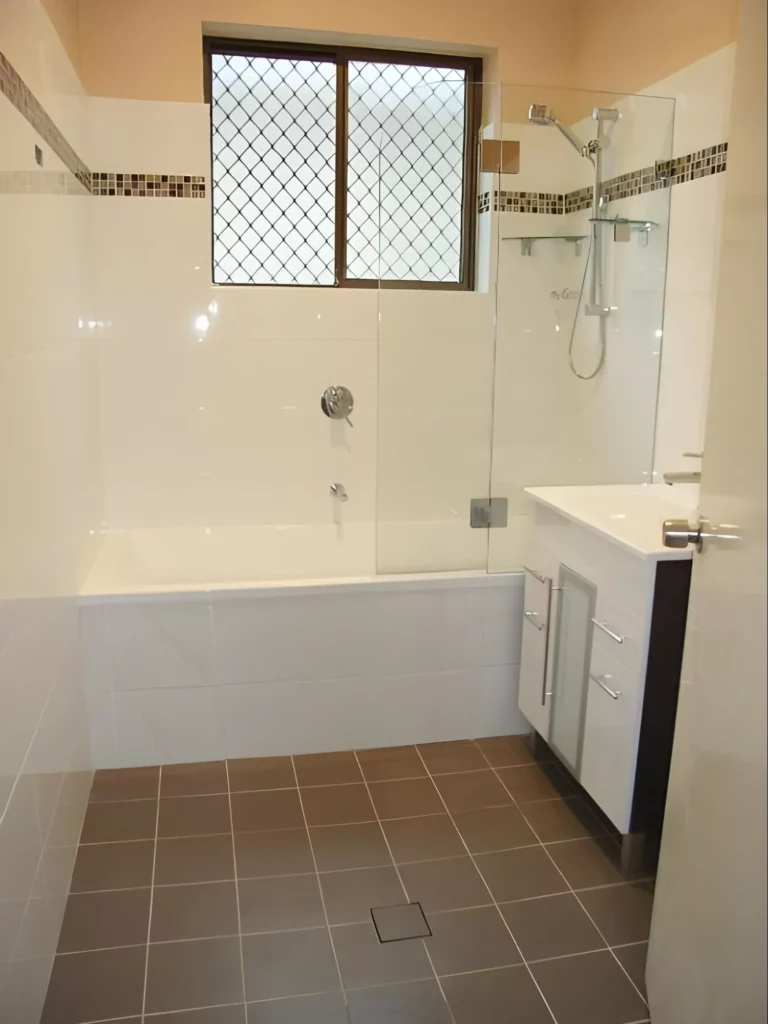Image of a renovated bathrom with a divider and low cabinet | Bathroom Renovations Lower North Shore | Prime Kitchens and Bathrooms