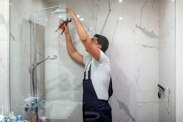 image of a constructor installing a shower during bathroom renovation